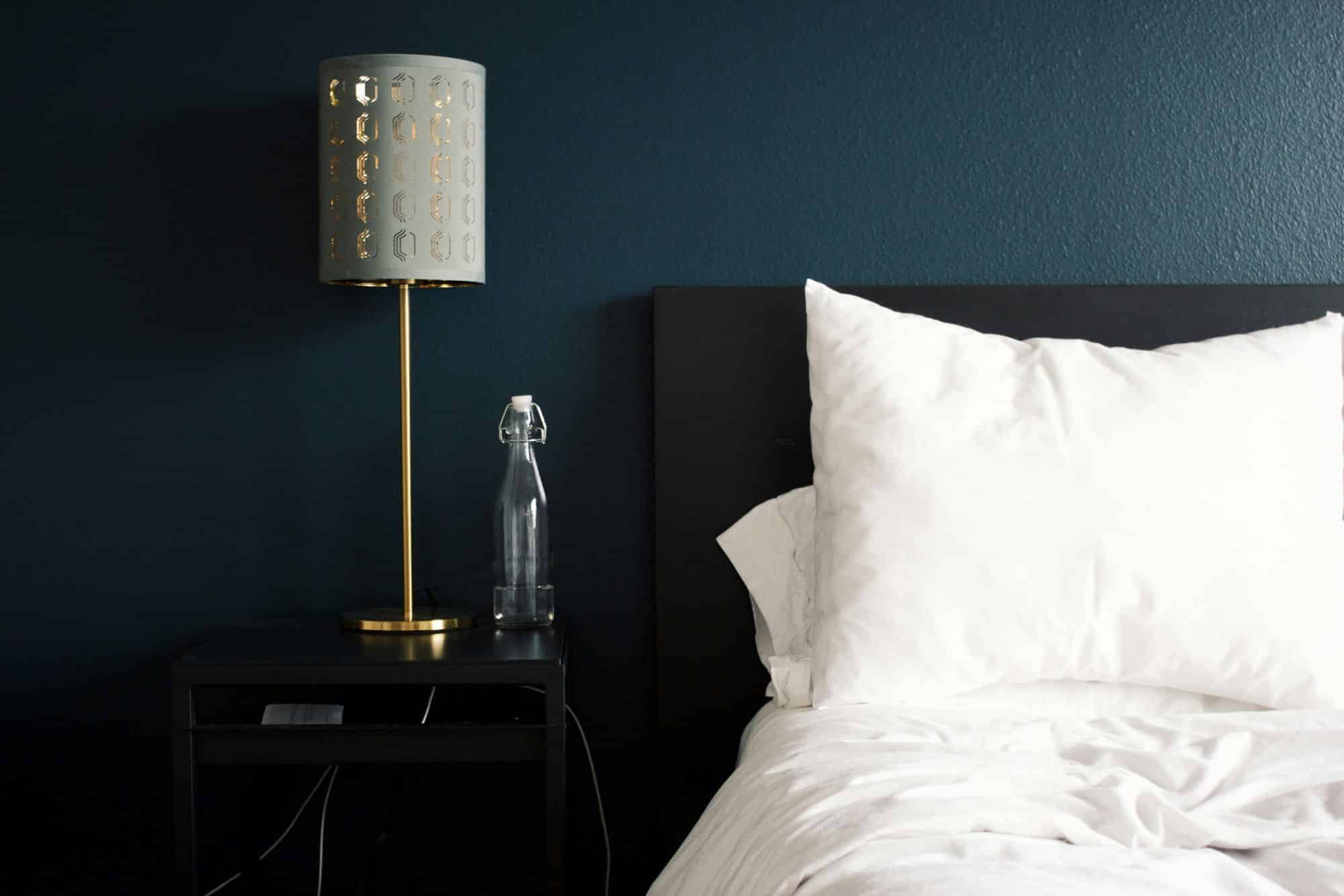 Bed with a side table and lamp