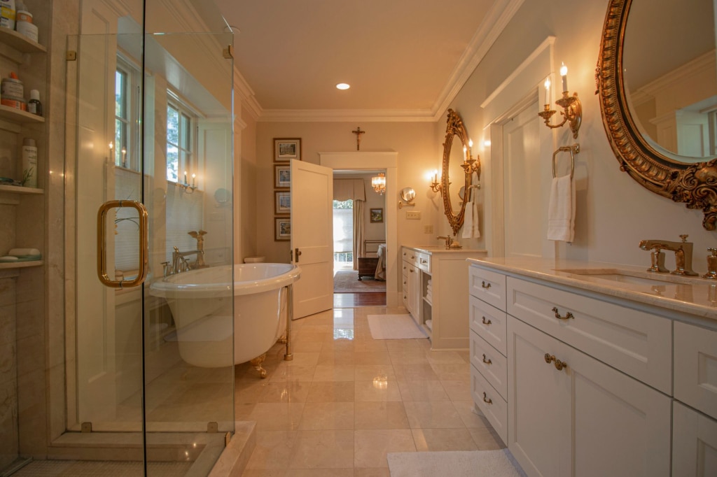 Large bathroom with a claw foot tub and a glass enclosed shower